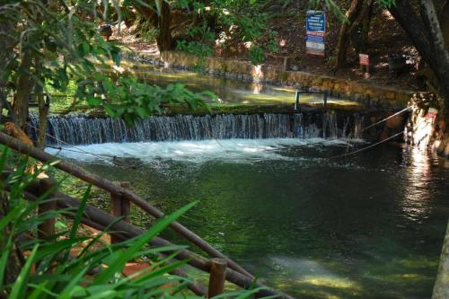 a waterfall in the middle of a river at Águas da Serra Apto 520A in Rio Quente