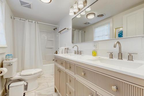 a white bathroom with a toilet and a sink at Town of Rehoboth Beach --- 33 Maryland Ave in Rehoboth Beach