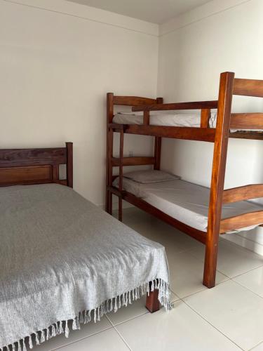 a bedroom with two bunk beds in a room at Casa ponta da tulha in Ilhéus