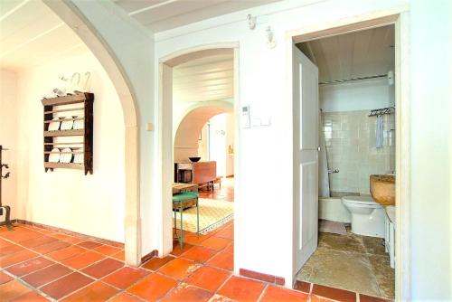a bathroom with a tub and a toilet in a room at Charming Coastside Villa in Colares