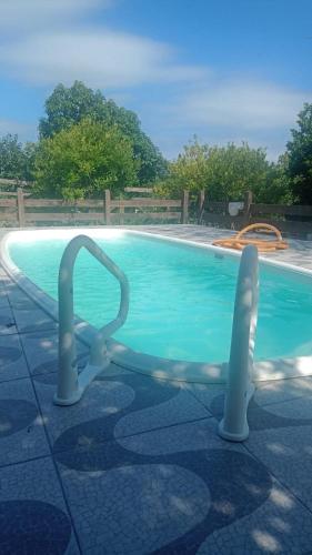 a swimming pool with a diving board in the water at Pousada Espírito Santo - Estamos ubicados a solo 100 metros de la Ruta BR-290 in São Gabriel