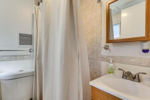 a bathroom with a shower curtain and a sink at Spacious Fanwood Home with Decks, Walk to Park! in Plainfield