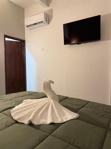 a white swan in a dress on a bed at El Suburbio - Aldama in Morelia
