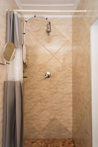 a shower in a bathroom with a shower curtain at Mindful Escape Cottage in Heathfield