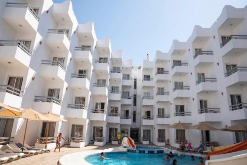 a building with a pool in front of it at Dexon Roma All Inclusive Hotel in Hurghada