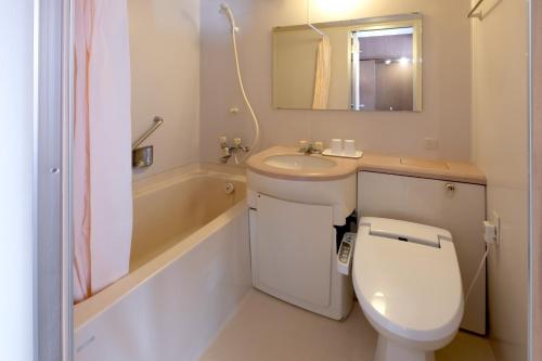 a bathroom with a toilet and a sink and a tub at Miyazaki Mango Hotel - Vacation STAY 58300v in Miyazaki
