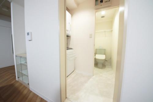 a bathroom with a toilet and a mirror at Miyazaki Mango Hotel - Vacation STAY 58309v in Miyazaki