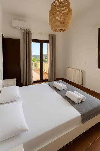 a bedroom with a large bed with two towels on it at Eros Villa-Private Luxury Estate in Pissouri