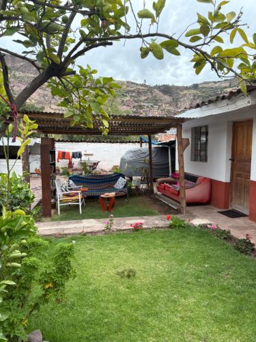 a house with a yard with a patio at hostel arcoiris urubamba in Urubamba