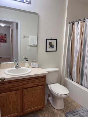a bathroom with a toilet and a sink and a shower at Toy Story Getaway Retreat in Kissimmee