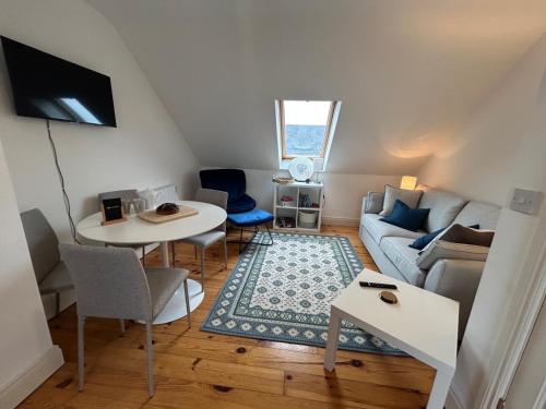 a living room with a couch and a table at Kinvara harbour retreat in Kinvara