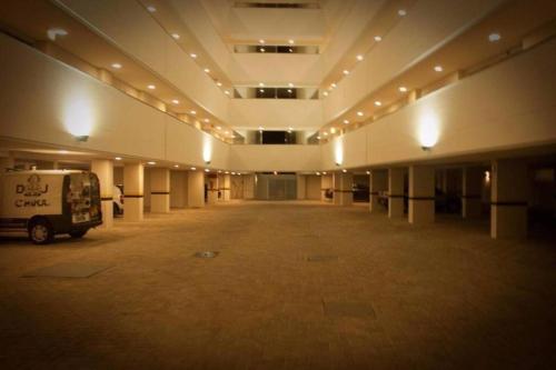 a large empty room with a van parked in it at Apartamento aconchegante a 100 metros da praia! in Porto Belo