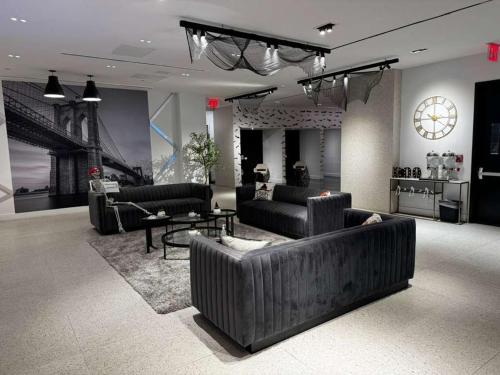 a large living room with couches and a table at Nova Hotel Brooklyn in Brooklyn