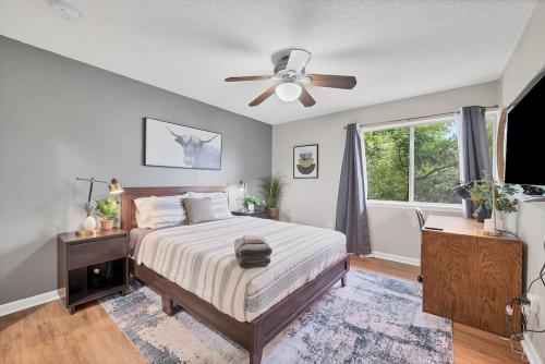 a bedroom with a bed and a ceiling fan at Boulder Basecamp - Cozy 2BR Near Trails & Town 