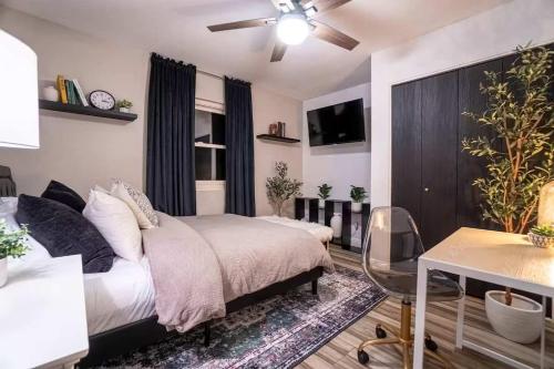 a bedroom with a bed and a tv in it at Cactus Luxury, Comfort, and Amenities galore! in Scottsdale