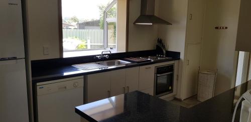 a kitchen with a sink and a counter top at Harmonious Social Retreat in Rotorua