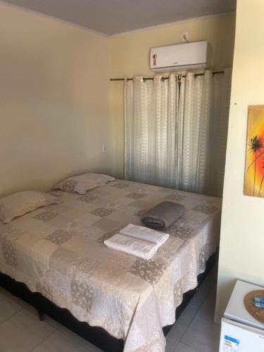 a bedroom with a bed with two towels on it at Pousada Maré do Cerrado in Mateiros