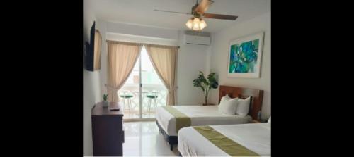 Ένα ή περισσότερα κρεβάτια σε δωμάτιο στο Cancún Plaza