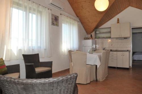 a kitchen and living room with a table and chairs at Villa Sofia in Povlja