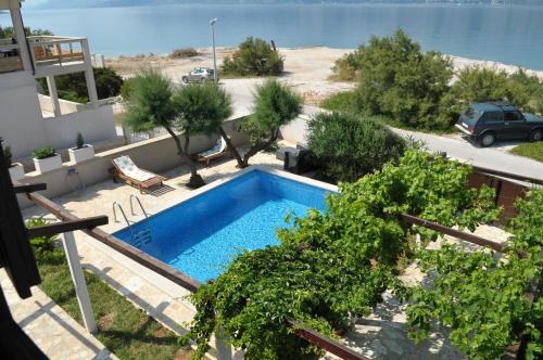 a swimming pool in the yard of a house at Villa Sofia in Povlja