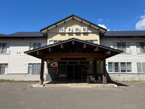 a building with a motorcycle parked in front of it at Suzuki Ryokan in Noboribetsu