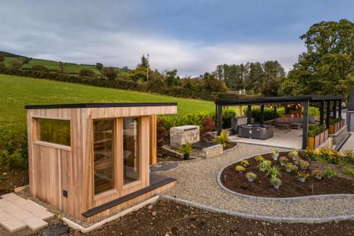 a house with a garden and a gazebo at Rosies Cottage in Rostrevor