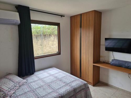 Ένα ή περισσότερα κρεβάτια σε δωμάτιο στο Paraíso Serra Negra Flat 05