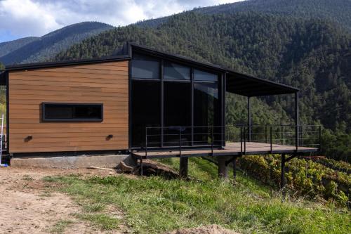 a house on top of a hill with mountains in the background at Suite en Viñedo in Arteaga