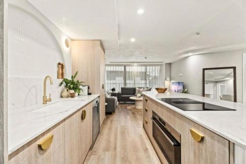 a kitchen with a sink and a counter top at Luxury Living on Monaco Riverfront - Hosted by Coastal Letting Co. in Gold Coast
