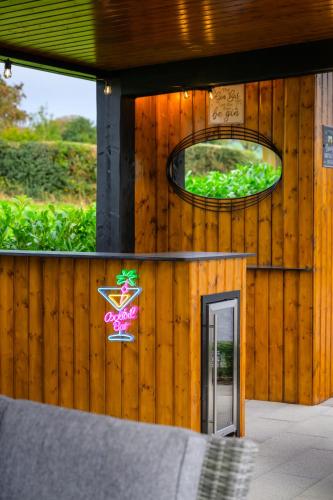 a wooden building with a door and a mirror at Rosies Cottage in Rostrevor