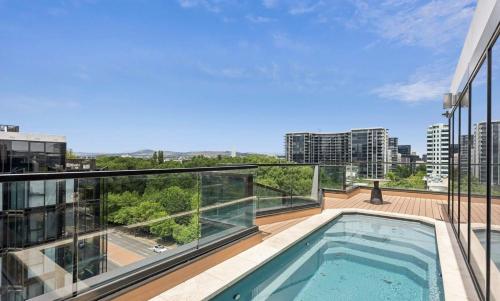 a balcony with a swimming pool on top of a building at 3 BRs topfloor view@Heart of Canberra free parking in Canberra