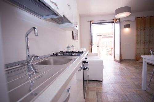 a kitchen with a sink and a stove at Ascoltando Il Mare in Lido Signorino
