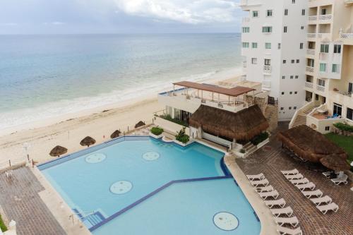 an overhead view of a hotel with a swimming pool and the beach at Condominio Cancún Plaza in Cancún