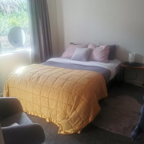 a bed sitting in a room with a window at Double Room Free WIFI in Hamilton