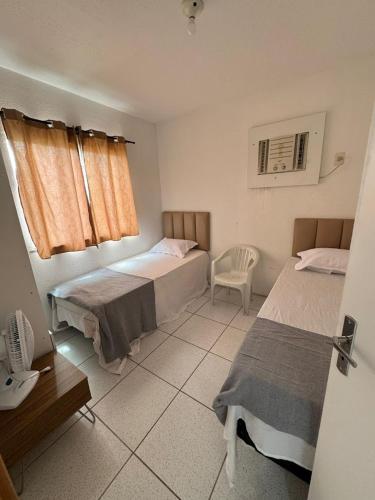 En eller flere senge i et værelse på Apartamento Mobiliado para seu conforto