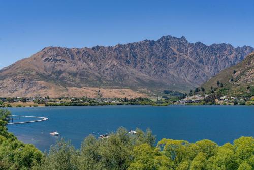 a view of a lake with mountains in the background at Charming Lakeview Home with Remarkable Views in Frankton Wharf