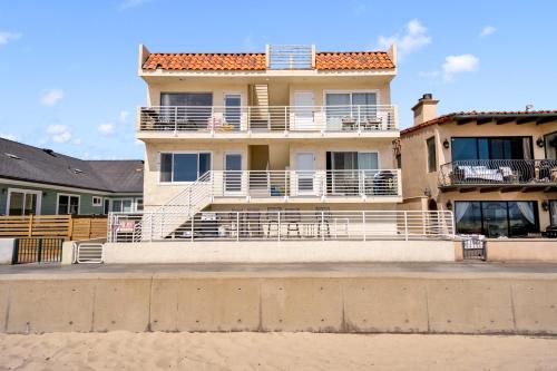 a large house with white balconies on a beach at Awesome On The Strand, Hermosa Beach Property in Hermosa Beach