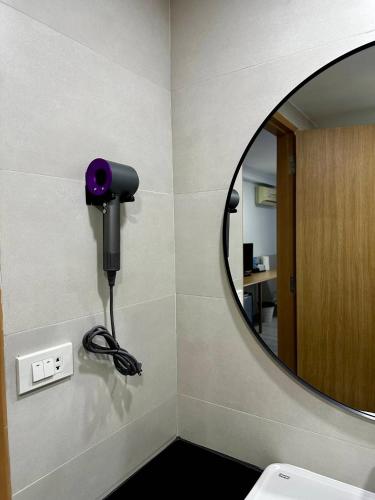 a bathroom with a mirror and a hair dryer at Garden Paradise in North Pattaya