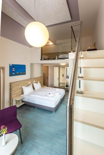 a hotel room with a bed and a staircase at Schumanns Garten in Weißenfels