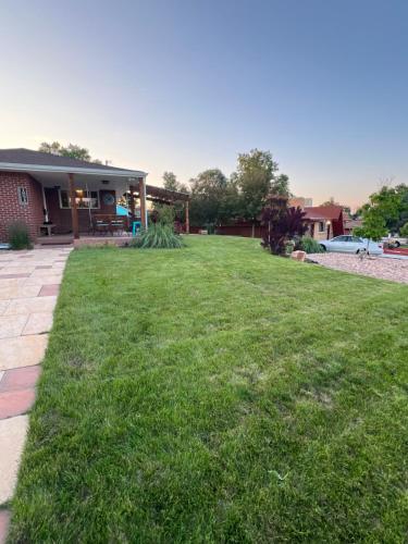 a yard of a house with a lawn at Su Casa Studio in Denver