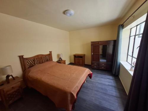 a bedroom with a bed and a window at Céntrico in Zacatecas