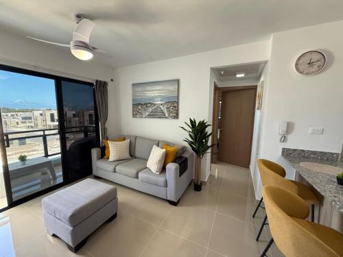 a living room with a couch and a table at Epic Sun in Punta Cana
