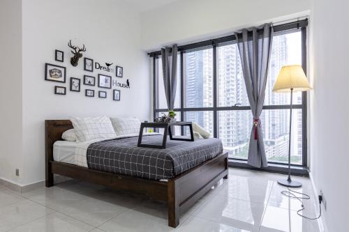 a bedroom with a bed and a large window at M City Ampang KLCC Lake view Pool in Kuala Lumpur