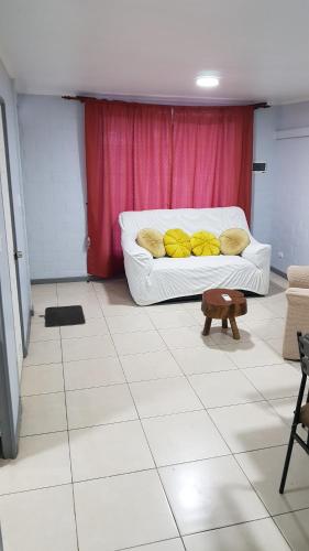 a white couch with yellow pillows in a room at Casa en Graneros in Graneros