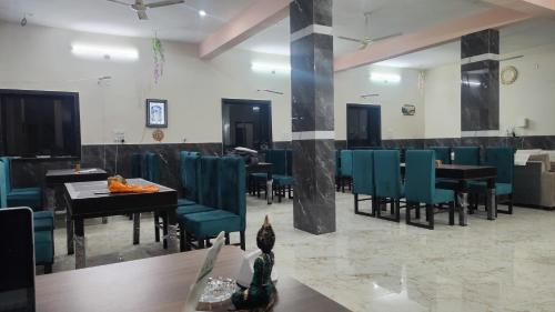 a dining room with blue chairs and tables at Hotel kamal hans palace in Udaipur