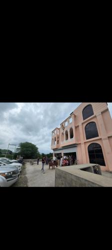 a building with a boat parked in front of it at Hotel kamal hans palace in Udaipur