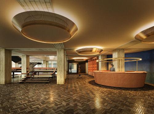 a lobby of a building with a person sitting at a desk at OMO7 Yokohama by Hoshino Resorts in Yokohama
