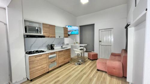 a kitchen with a couch and a stove top oven at Moon House Granada in Estación El Salto
