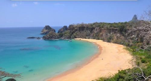 a view of a beach with rocks in the ocean at O Paraíso Mar de Vênus in Fernando de Noronha