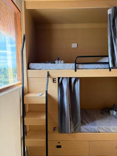 two bunk beds in a room with a window at Isa- Hostel in Panglao